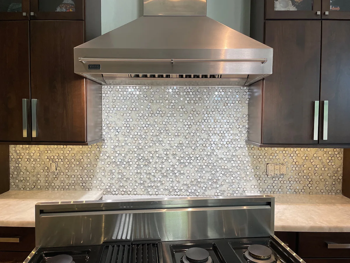 Kitchen remodel with custom range hood and mosaic backsplash